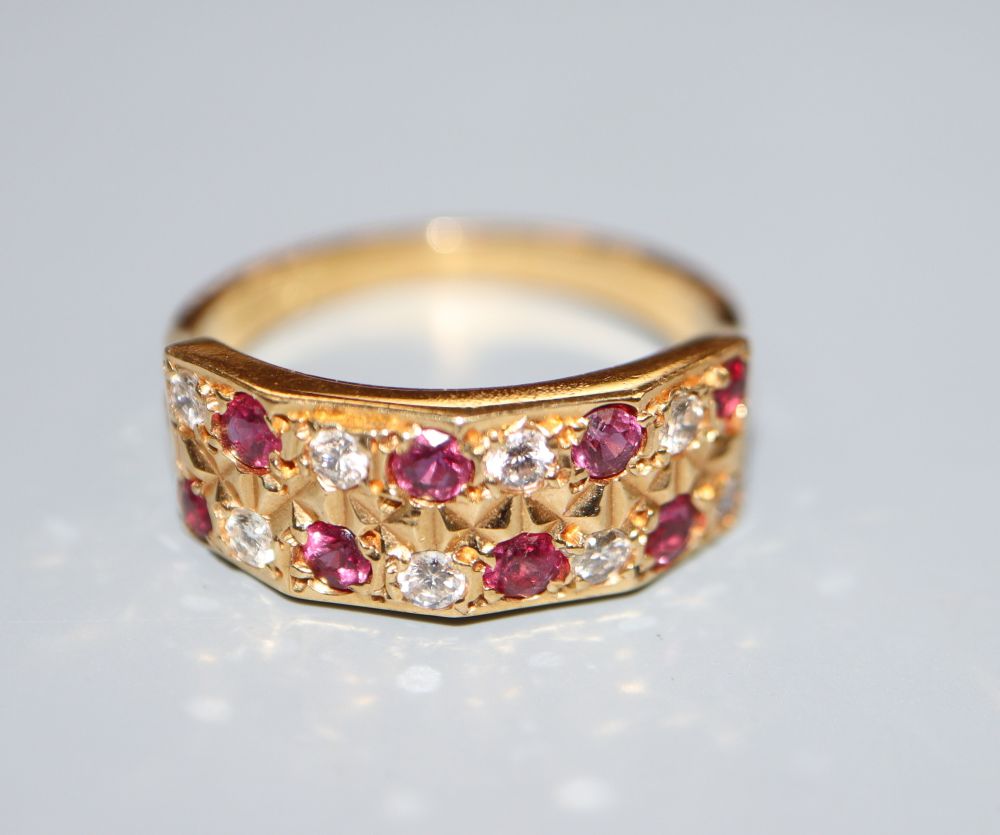 A modern 18ct, eight stone ruby and eight stone diamond set half hoop dress ring, size L/M, gross 3.7 grams.